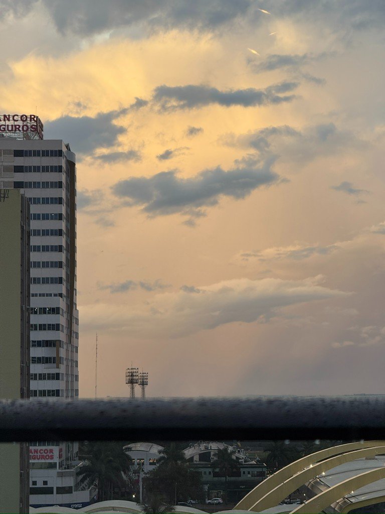 golden cloudy sky over a high rise and floodlights